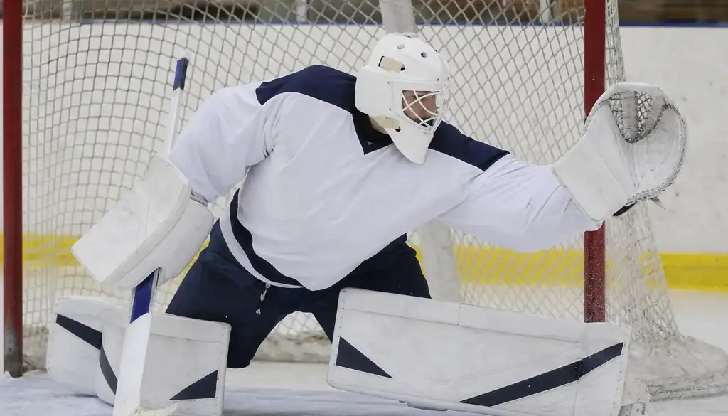 Goaltender making a glove save, the starting goalie is a key factor when handicapping NHL bets